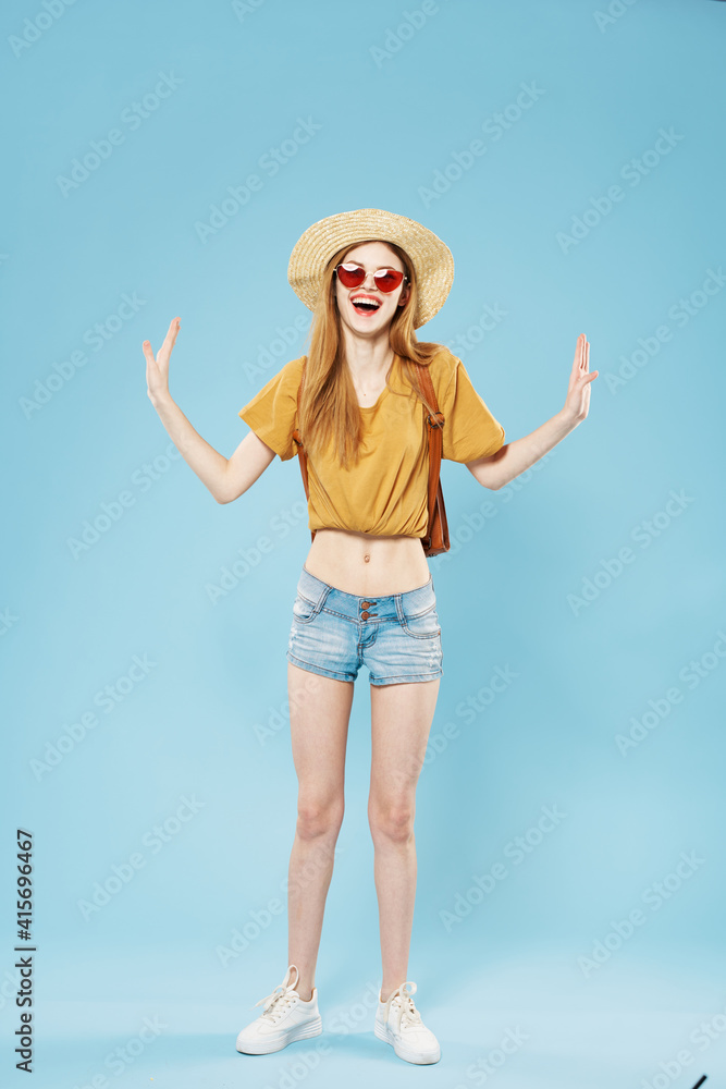 Beautiful elegant woman in hat fashion clothes backpack studio blue background Beautiful elegant woman in hat fashion clothes backpack studio blue background