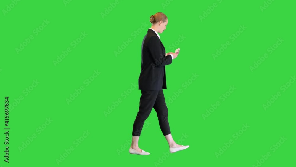 Young blonde girl counting euros while walking on a Green Screen, Chroma Key. Young blonde girl counting euros while walking on a Green Screen, Chroma Key.