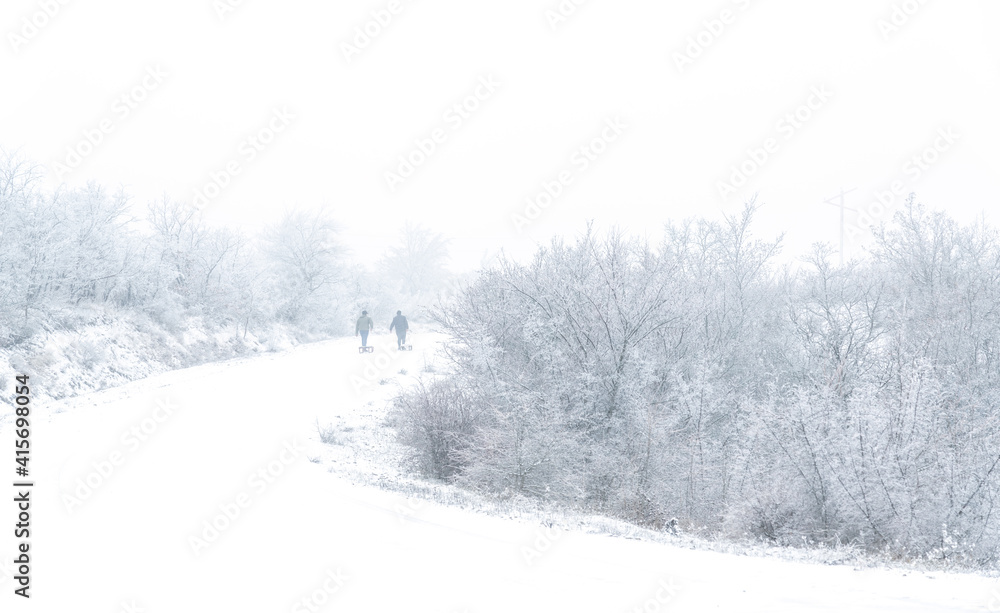 Guys with a sleigh on a snowy mountain road Guys with a sleigh on a snowy mountain road