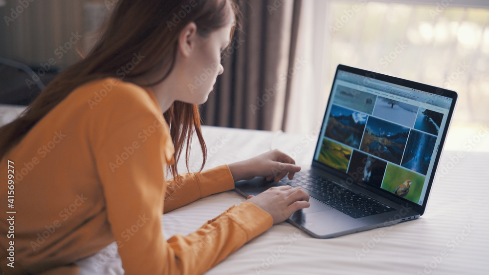 woman lies in bed in front of laptop freelance communication woman lies in bed in front of laptop freelance communication