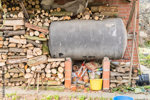 In addition to the facade, there is a fuel oil tank and piles of wood