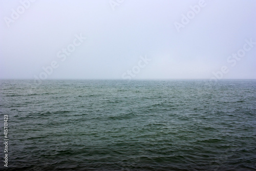 Fototapeta Naklejka Na Ścianę i Meble -  Dark green sea surface in fog