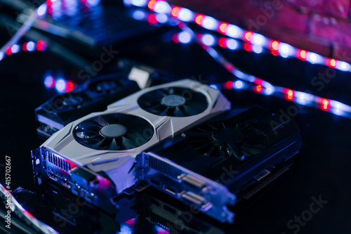 The video cards are on the table in a row one after the other. A component part of a computer for cryptocurrency mining and games