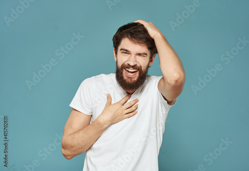 joyful man touching his head with his hands happiness emotions blue background