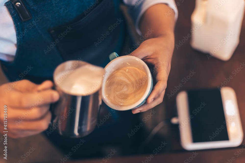 Barista making cappuccino, bartender prepare coffee drink at coffee shop .