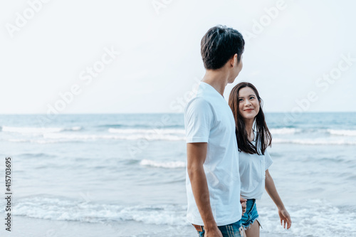 Couple walking on the beach.