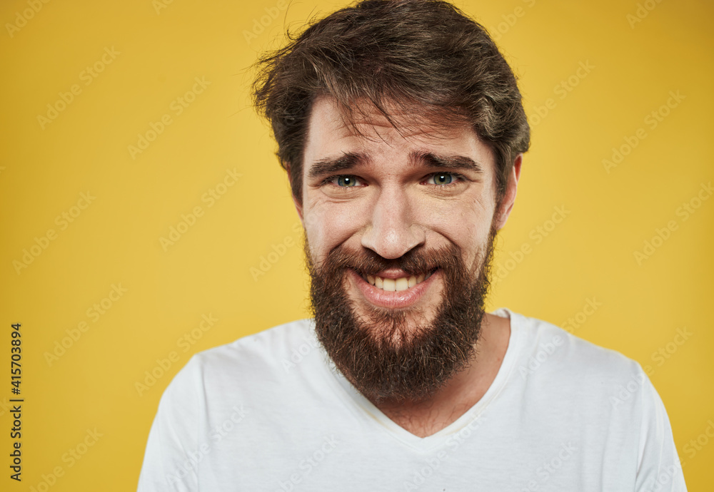 Emotional man with thick beard grinning model yellow background Emotional man with thick beard grinning model yellow background