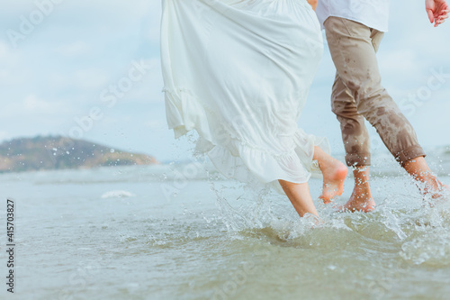 Love young couple running on the beach. Holiday and vocation concept.