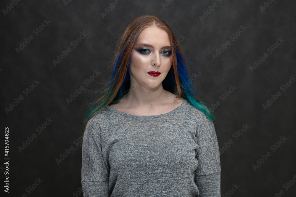 Portrait of a caucasian model with bright makeup and long hair on a black background Portrait of a caucasian model with bright makeup and long hair on a black background