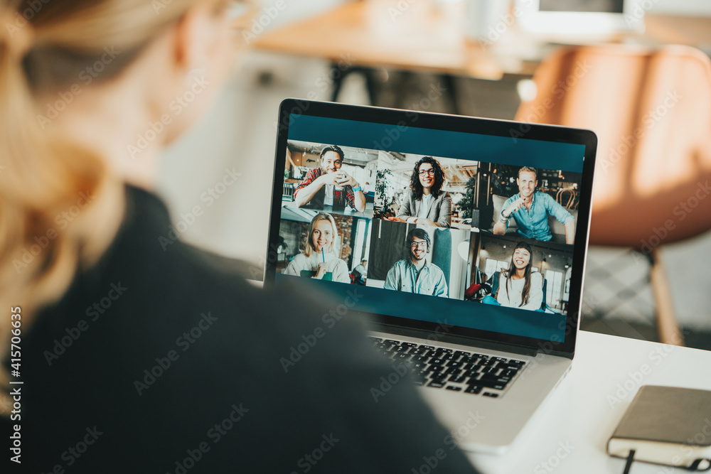 © Alex from the Rock - Woman has video call with her remote team using laptop and camera