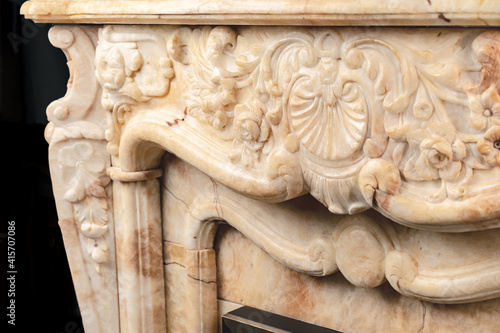 Carved patterns on stone luxury fireplace close up