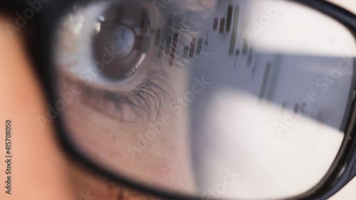 Online Trading Stock Market. Entrepreneur Analyzing Data, closeup eye glasses reflection photo