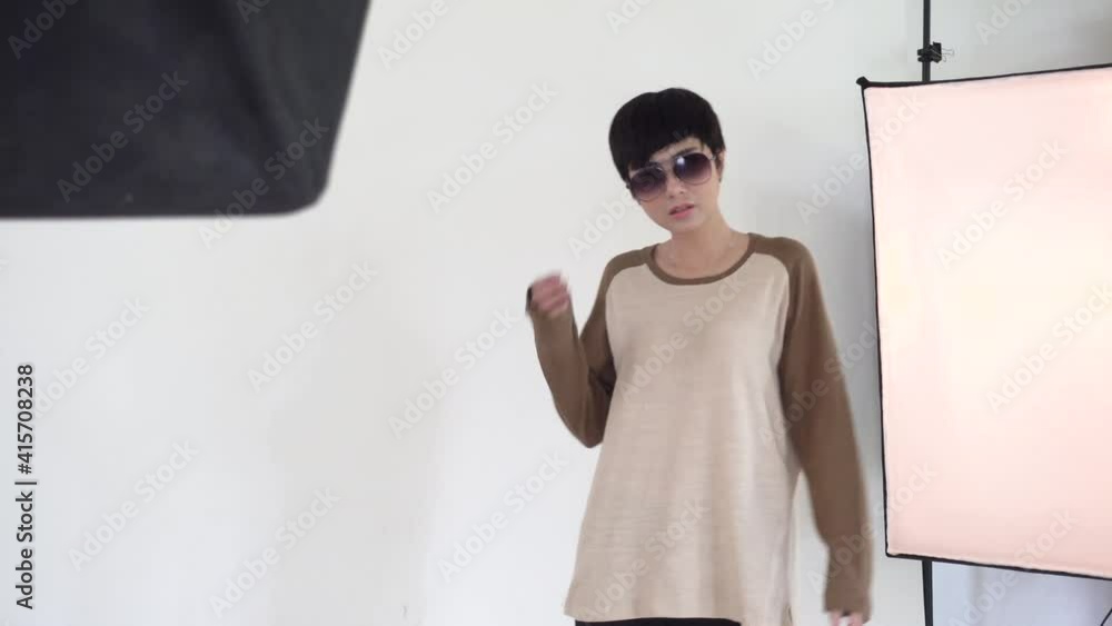 Behind the scenes on photo shoot, beautiful asian model posing for