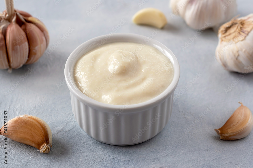 Lebanese Toum garlic sauce. All-purpose garlic sauce (no eggs) as an alternative to mayonnaise. It goes well with all dishes where garlic is appropriate. Selective focus. Lebanese Toum garlic sauce. All-purpose garlic sauce (no eggs) as an alternative to mayonnaise. It goes well with all dishes where garlic is appropriate. Selective focus.