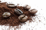 Close-up of whole coffee beans, ground and a cup
