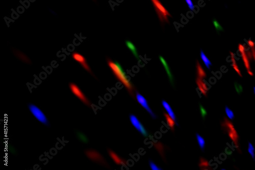 Blur colorful neon light leaks on black background. Defocused illuminated abstract futuristic texture for using over photos as overlay or screen filter