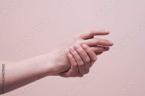 Beautiful female hands on pink background. Closeup  copy space. Cosmetology and skin care concept