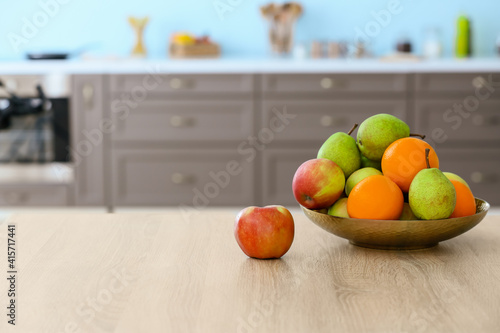 Plate with fruits on table ...
