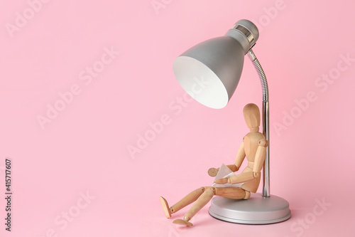 Wooden mannequin with lamp ...