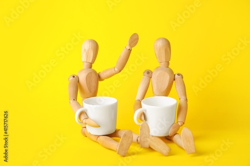 Wooden mannequins with cups...