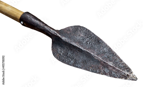 Old historic arrow with forged iron arrowhead and wooden shaft isolated on white background, ancient medieval weapon used for hunting or warfare in historical times