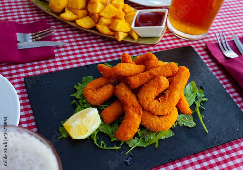 Sepia fried in bread crumbs, served with arugula and lemon. Spanish cuisine