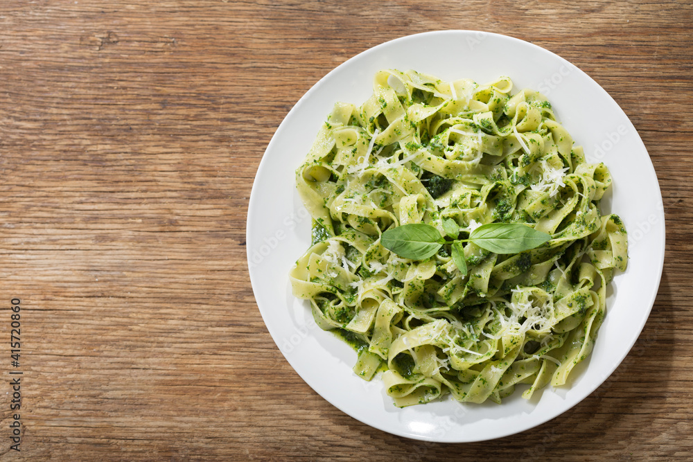 plate of pasta with pesto sauce, top view