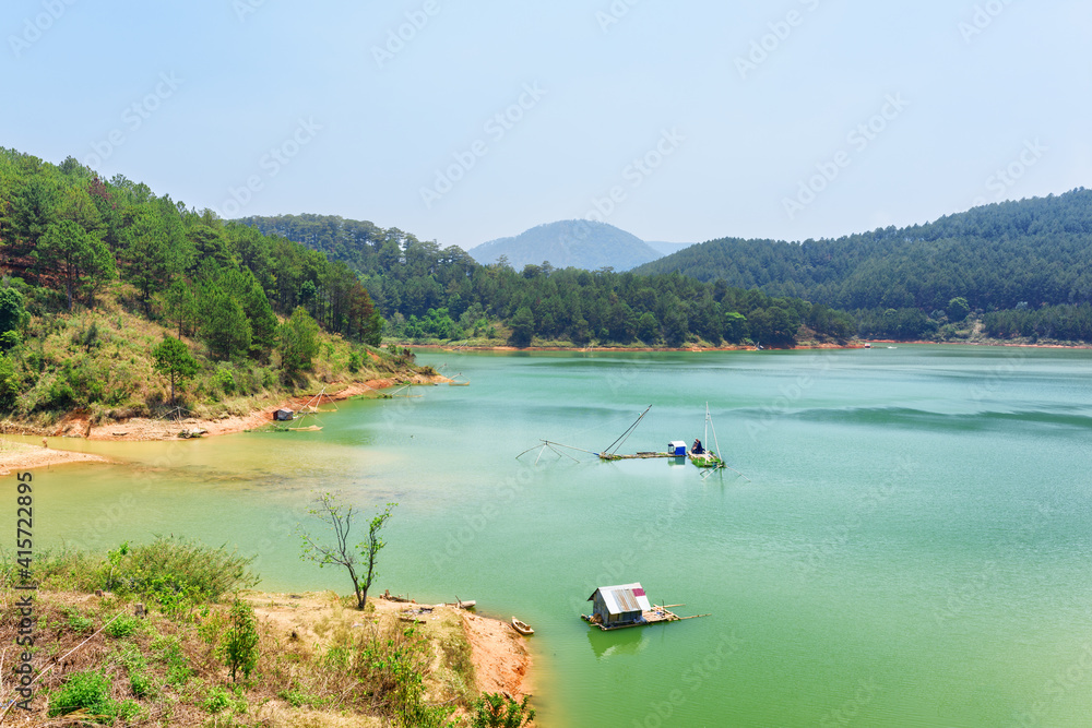 Amazing lake with azure water among green woods