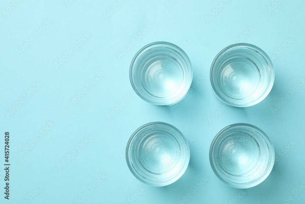 Full shots or glasses on blue background, top view