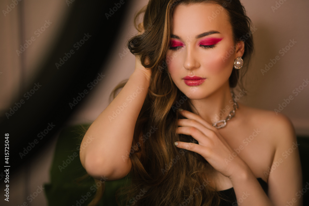 Close up portrait of young beautiful woman with creative holiday makeup.