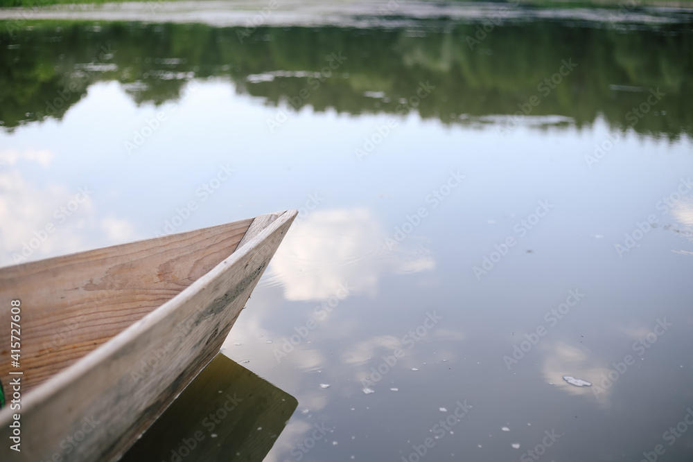 Old small wooden rowboat boat stands by the lake Old small wooden rowboat boat stands by the lake