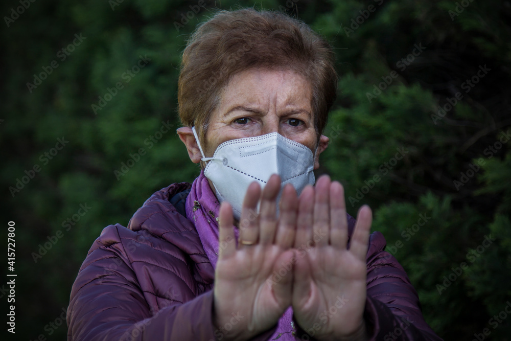 senior woman with medical mask and gloves making stop symbol with her hands. quarantine. Corona Virus health concept senior woman with medical mask and gloves making stop symbol with her hands. quarantine. Corona Virus health concept