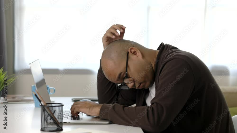 Tired businessman working with laptop. He covered his mouth with his hand and yawned. He is very sleepy. He work from home.
Tired businessman working with laptop. He covered his mouth with his hand and yawned. He is very sleepy. He work from home.