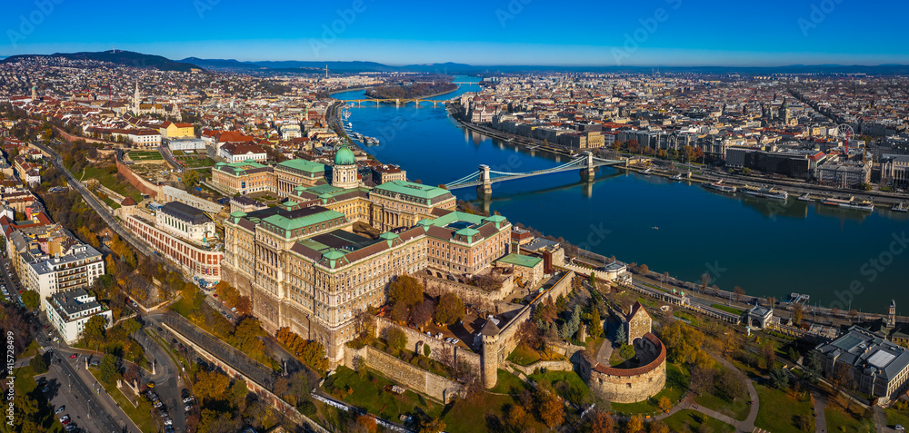 Budapest, Hungary - Aerial panoramic skyline of Budapest. Buda Castle Royal Palace, Szechenyi Chain Bridge, Parliament building, River Danube and Matthias church on a sunny autumn day with blue sky