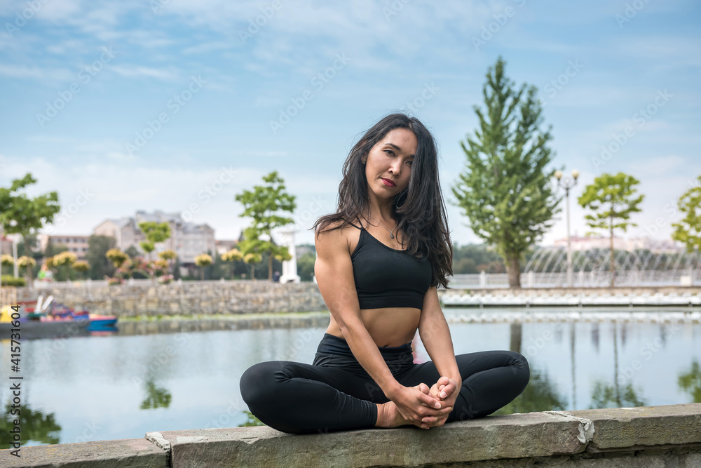 Young slim woman in sportswear practicing yoga near lake, nature. Healthy lifestyle Young slim woman in sportswear practicing yoga near lake, nature. Healthy lifestyle