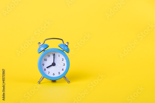 The alarm clock shows 8 am. Morning time. Clock face. Yellow background, deadline concept. Copy space, empty place for text. Business template. Bright color mockup. Layout.