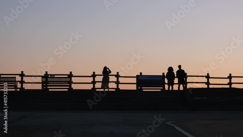 silhouette of a person sunset on haneul park, seoul city photo