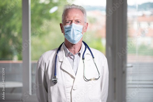 Portrait of doctor with arms crossed wearing a face mask