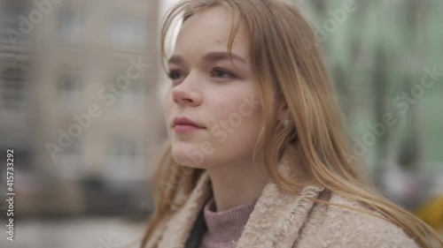 A woman walks in the yard along a volleyball net. Close-up.