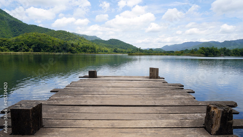 Fototapeta Naklejka Na Ścianę i Meble -  Empty wooden bridge or table top with the lake mountain and sky landscape. Wood floor with lake mountain and sky of nature park background and summer season, product display montage.