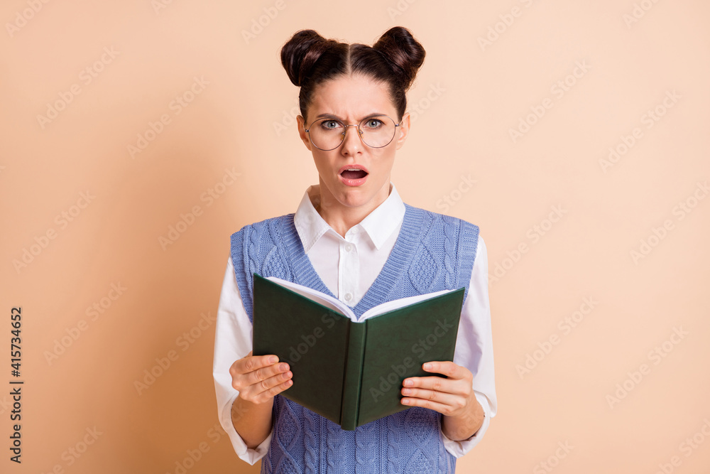 Photo of brunette stressed lady read book wear spectacles white shirt blue vest isolated on beige color background Photo of brunette stressed lady read book wear spectacles white shirt blue vest isolated on beige color background