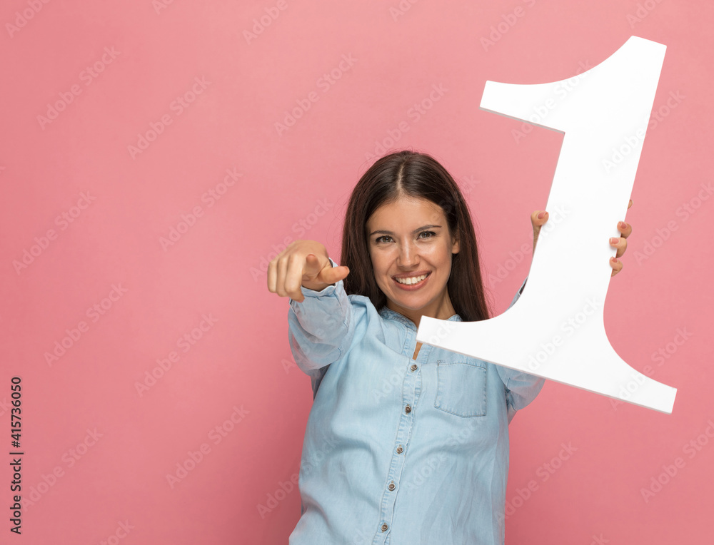 young casual woman pointing at the camera young casual woman pointing at the camera