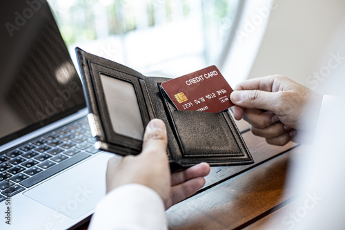 Men are pulling their credit cards out of their wallets. He is about to pay for food by credit card at restaurants, credit cards can be used for general stores and online shopping. Credit card concept