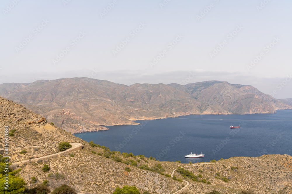 view of the Sierra de Muela mountains and the Bay of Cartagena in Murcia with moored freight ships at anchor