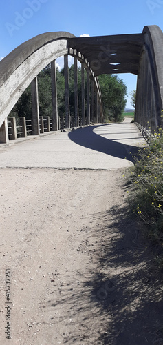big old white bridge to cross a river 