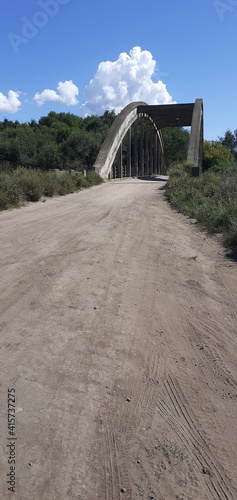 big old white bridge to cross a river 