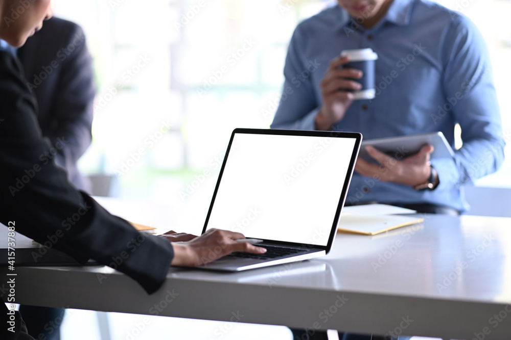 Cropped shot of businesspeople working with computer laptop and discussing the situation on the market at meeting room. Cropped shot of businesspeople working with computer laptop and discussing the situation on the market at meeting room.