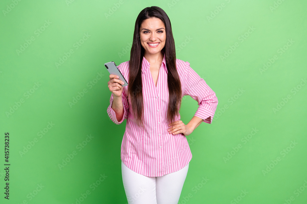 Portrait of attractive cheerful girl holding in hands device blogging browsing app 5g isolated over green pastel color background Portrait of attractive cheerful girl holding in hands device blogging browsing app 5g isolated over green pastel color background