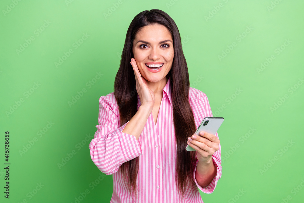 Portrait of attractive cheerful girl holding in hands using gadget browsing good news smm app isolated over green pastel color background Portrait of attractive cheerful girl holding in hands using gadget browsing good news smm app isolated over green pastel color background