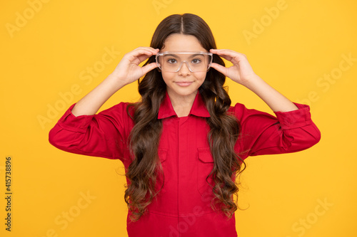 smiling teenager girl wearing protective glasses, eye protection